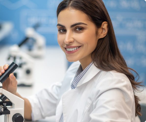 A smiling researcher at a lab bench